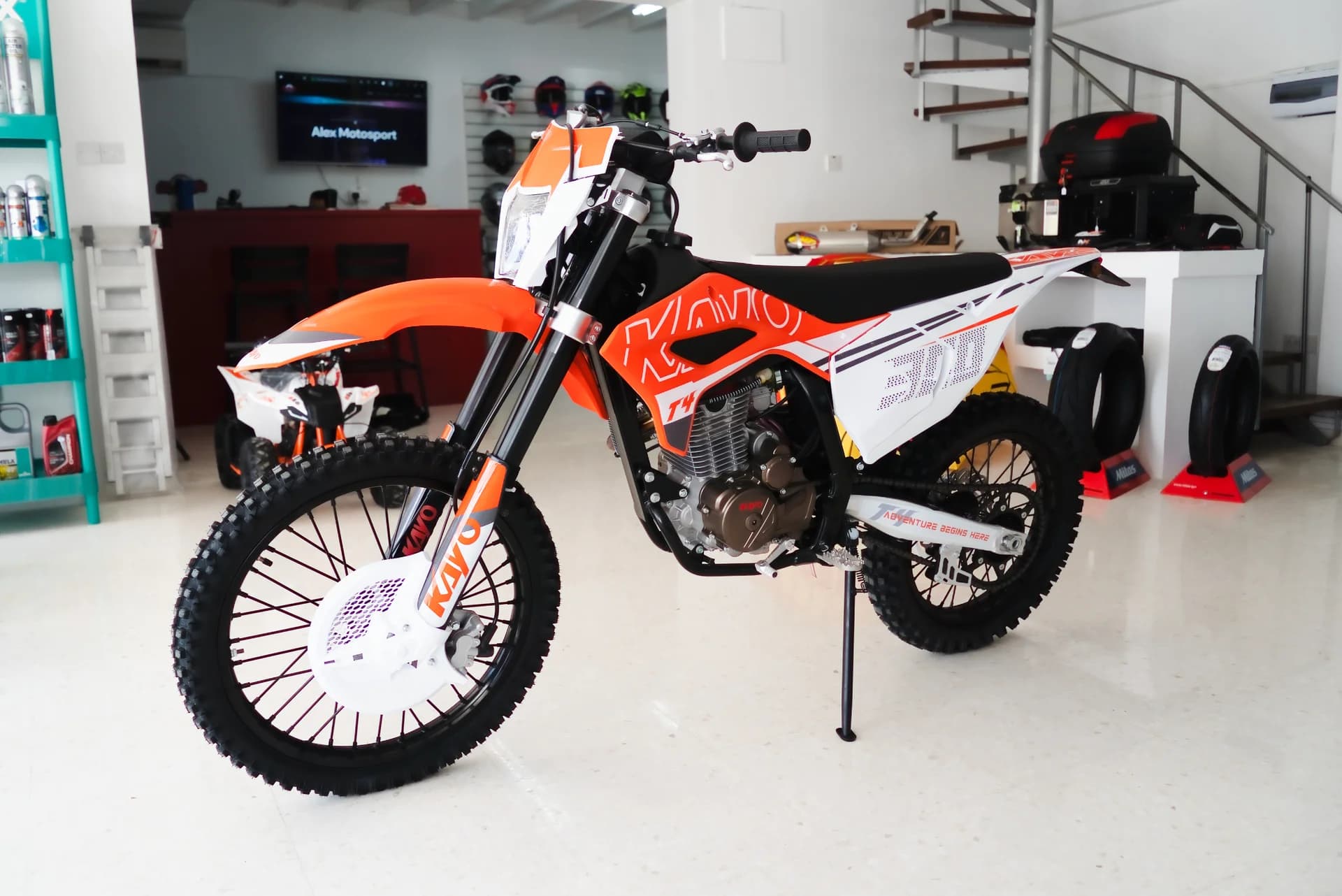 Orange and white Kayo T4 300 photographed inside Alex Motosport’s new Paphos shop